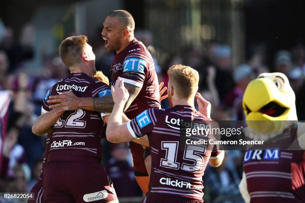 Frank Winterstein of the Sea Eagles and team mates celebrate a try during the round 22 NRL match between the Manly Warringah Sea Eagles and the...