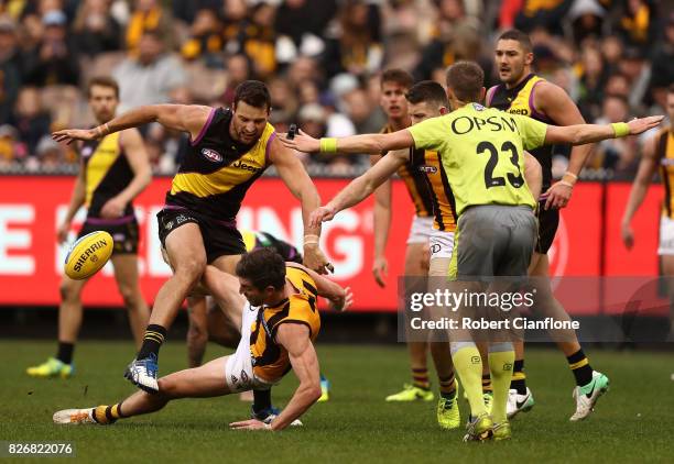 Toby Nankervis of the Tigers knocks over Ricky Henderson of the Hawks during the round 20 AFL match between the Richmond Tigers and the Hawthorn...