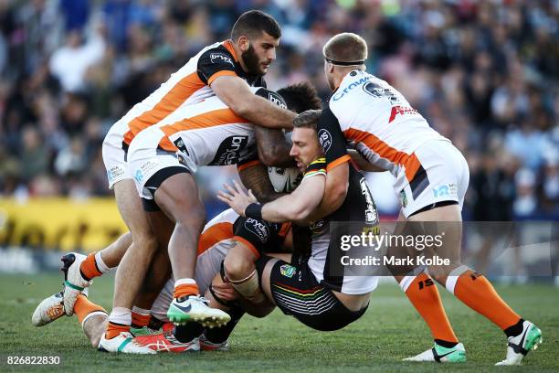 Bryce Cartwright of the Panthers is tackled during the round 22 NRL match between the Penrith Panthers and the Wests Tigers at Pepper Stadium on...