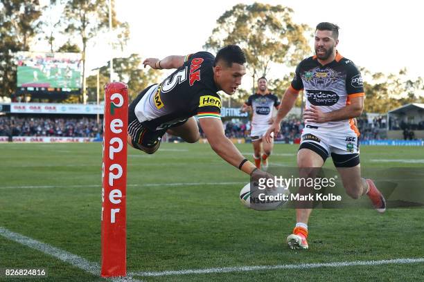 Dallin Watene-Zelezniak of the Panthers scores a try during the round 22 NRL match between the Penrith Panthers and the Wests Tigers at Pepper...