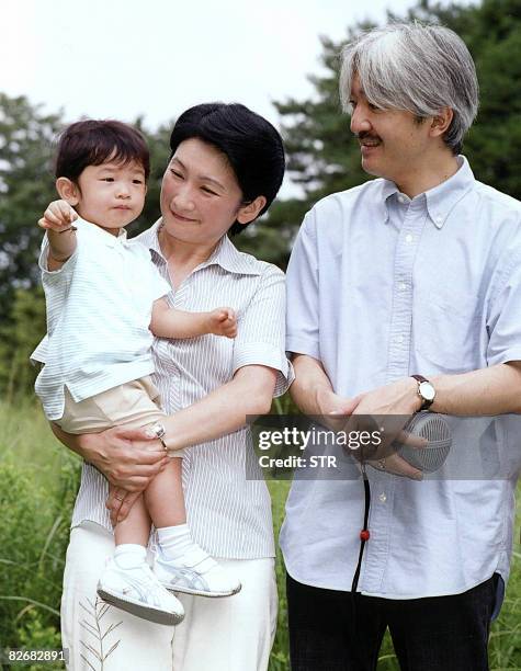 Photo released by the Imperial Household Agency show Japanese Prince Hisahito being held by his mother Princess Kiko as his father Prince Akishino...