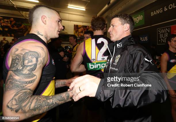 Dustin Martin of the Tigers and Tigers head Damien Hardwick celebrate after the Tigers defeated the Hawks during the round 20 AFL match between the...