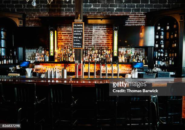 interior of empty bar at night - bar counter stock pictures, royalty-free photos & images