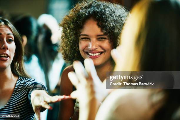 laughing woman hanging out with friends in bar - café bar 個照片及圖片檔