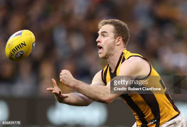 Tom Mitchell of the Hawks handballs during the round 20 AFL match between the Richmond Tigers and the Hawthorn Hawks at Melbourne Cricket Ground on...