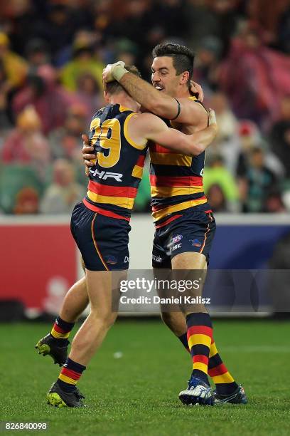 Rory Laird of the Crows celebrates with Taylor Walker of the Crows after kicking a goal during the round 20 AFL match between the Adelaide Crows and...