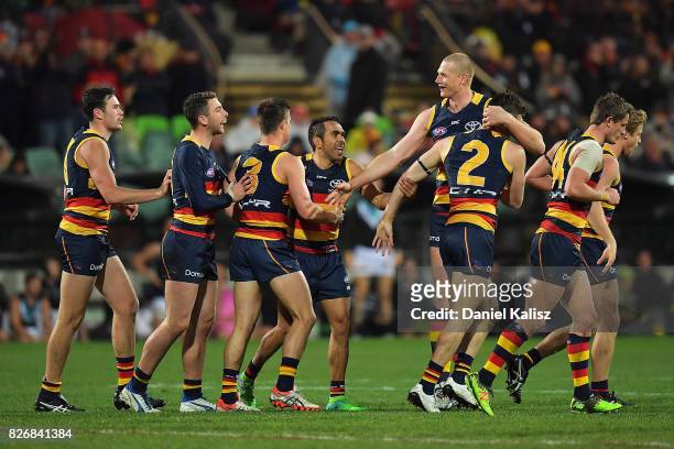 Crows players celebrate after scoring a goal during the round 20 AFL match between the Adelaide Crows and the Port Adelaide Power at Adelaide Oval on...