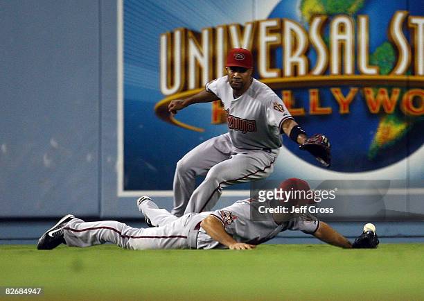 Left fielder Conor Jackson of the Arizona Diamondbacks dives but can't come up with a ball hit by Russell Martin of the Los Angeles Dodgers in the...