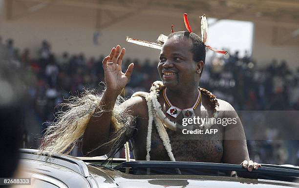 King Mswati III waves to the crowd as he arrives at the Somhlolo Stadium on September 6, 2008 in Lobombo prior to celebrate the 40th anniversary of...