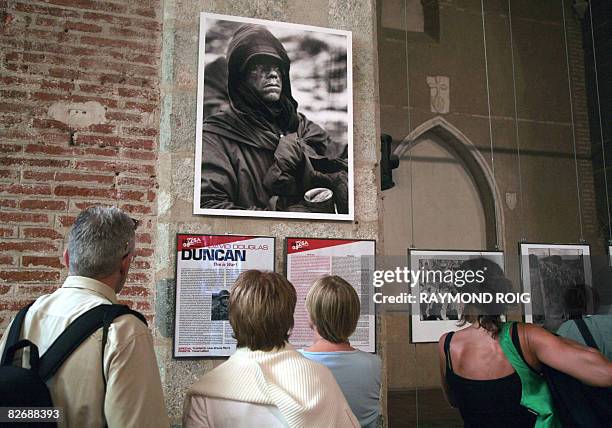 People look at pictures of photojgrapher David Douglas-Duncan shown during the "Visa pour l'image" photo festival on September 6, 2008 in Perpignan,...