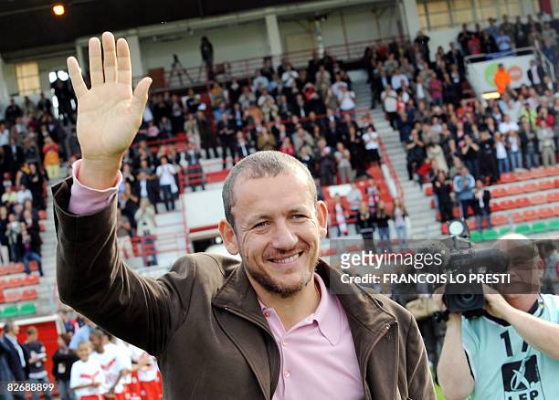 French actor and comedian Dany Boon waves to the crowd on September 6, 2008 at the Nungesser stadium in Valenciennes, northern France prior to a...