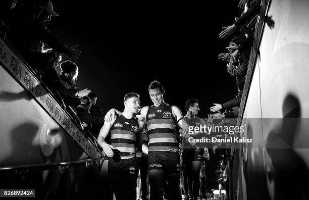Rory Laird and Tom Lynch of the Crows walk from the field after the round 20 AFL match between the Adelaide Crows and the Port Adelaide Power at...