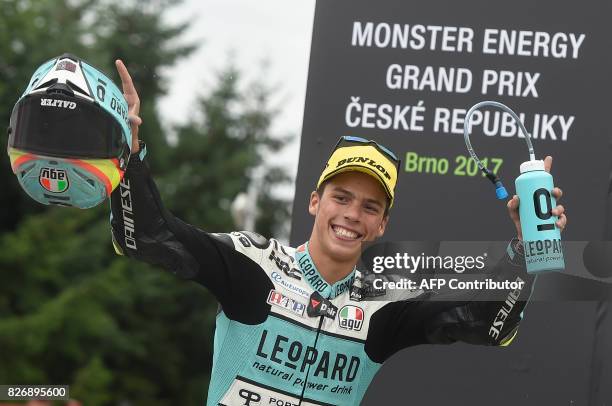 Joan Mir of Spain celebrates on the podium after winning the Moto3 event of the Grand Prix of the Czech Republic in Brno on August 6, 2017. / AFP...