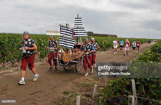 Runners in costume move through the Medoc wine region during the Marathon Du Medoc race on September 6, 2008 near Pauillac, France. The marathon runs...