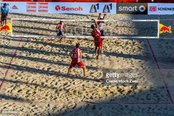 Clemens Doppler and Alexander Horst of Austria competes against Piotr Kantor and Bartosz Losiak of Poland during Day 9 of the FIVB Beach Volleyball...