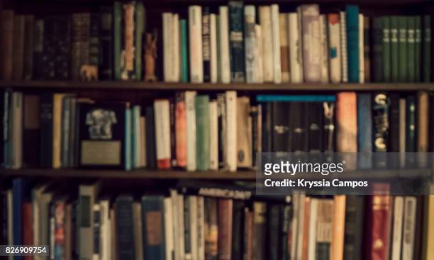 defocused image of bookshelf - literature stock pictures, royalty-free photos & images