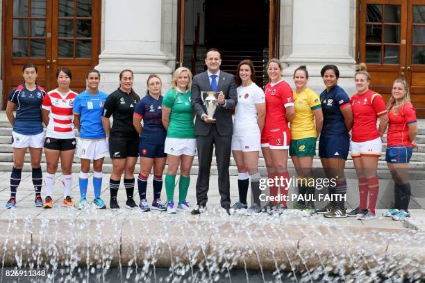 Ireland's Prime Minister Leo Varadkar poses with the trophy, flanked by Hong Kong's captain Chow Mei Nan, Japan's captain Seina Saito, Italy's...