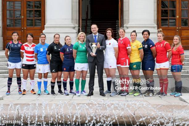 Ireland's Prime Minister Leo Varadkar poses with the trophy, flanked by Hong Kong's captain Chow Mei Nan, Japan's captain Seina Saito, Italy's...