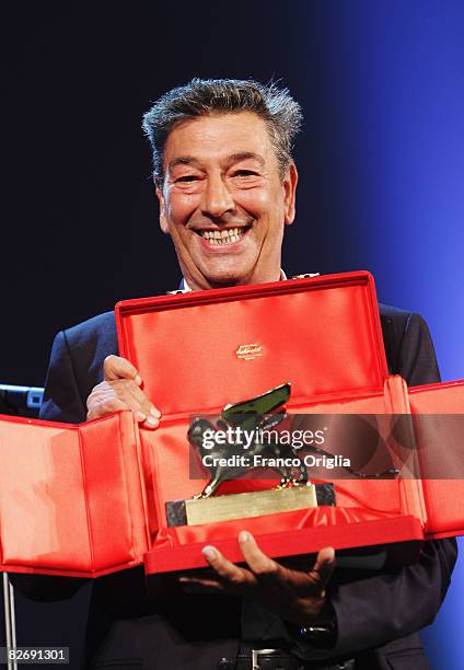 Director Gianni di Gregorio poses with the Opera Prima "Luigi De Laurentiis" Award for the movie "Pranzo di Ferragosto" at the 65th Venice Film...