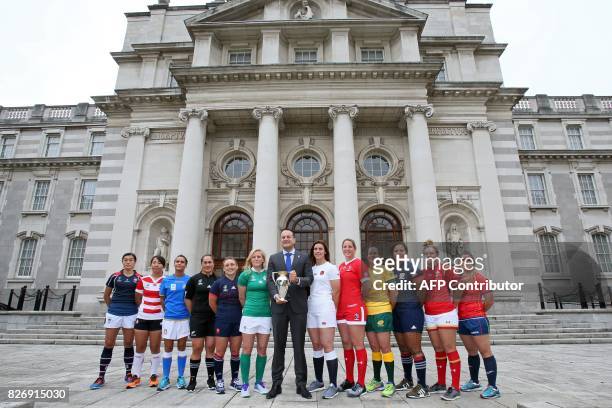 Ireland's Prime Minister Leo Varadkar poses with the trophy, flanked by Hong Kong's captain Chow Mei Nan, Japan's captain Seina Saito, Italy's...