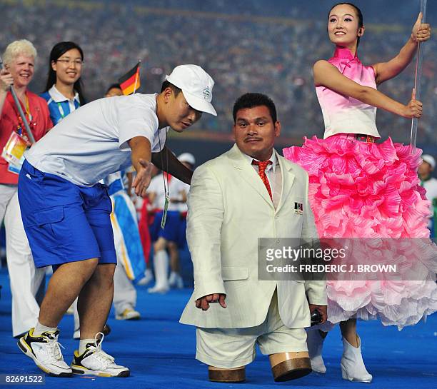 Volunteer speaks to a member of the Mexican delegation as athletes parade during the opening ceremony of 2008 Paralympic Games in Beijing on...