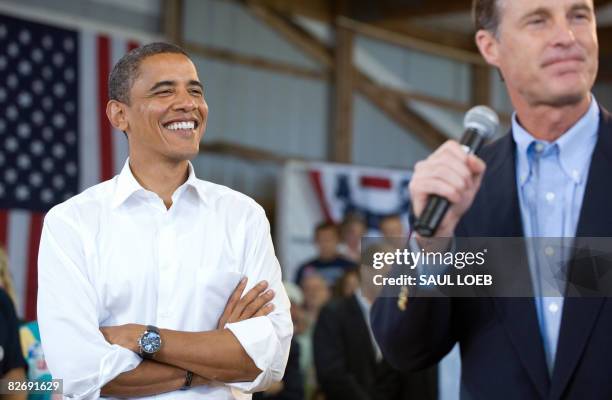 Democratic presidential candidate Illinois Senator Barack Obama listens to his introduction by Indiana Senator Evan Bayh during a town hall meeting...