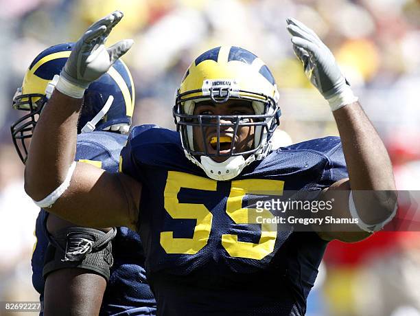 Brandon Graham of the Michigan Wolverines tries to get the crowd louder during fourth quarter action against the Miami of Ohio Red Hawks on September...