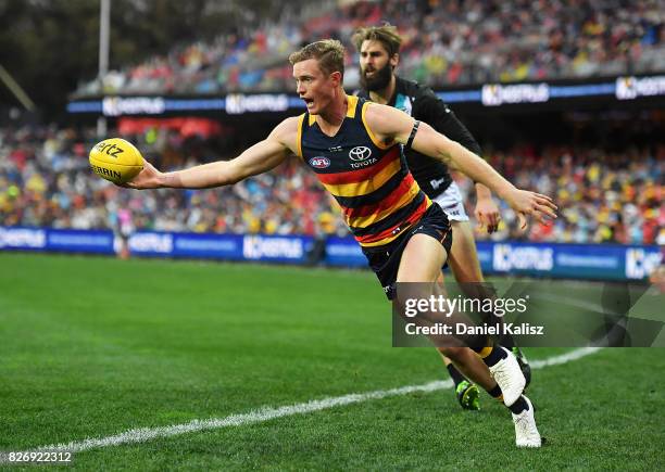 Jonathon Beech of the Crows keeps the ball in play during the round 20 AFL match between the Adelaide Crows and the Port Adelaide Power at Adelaide...