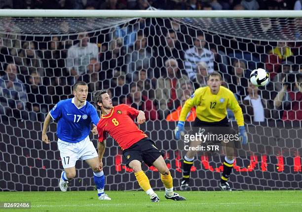Belgian Steven Defour and Estonia's Enar Jaager fight for the ball in front of Estonia keeper Artur Kotenko during the World Cup 2010 qualification...