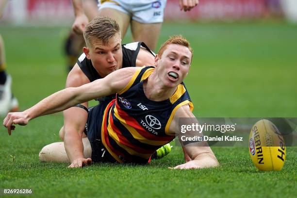 Tom Lynch of the Crows and Ollie Wines of the Power compete for the ball during the round 20 AFL match between the Adelaide Crows and the Port...