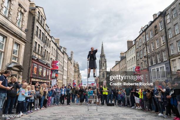 Fringe participant promotes his show entertaining people on the Royal Mile during the third day of the annual Edinburgh Fringe Festival on August 6,...