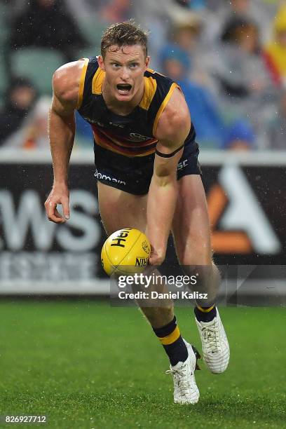 Alex Keath of the Crows handballs during the round 20 AFL match between the Adelaide Crows and the Port Adelaide Power at Adelaide Oval on August 6,...