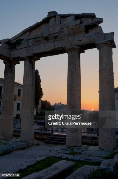 ruined temple in roman agora at sunset. - oude agora stockfoto's en -beelden