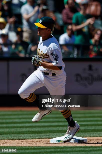 Jaycob Brugman of the Oakland Athletics rounds the bases after hitting a home run against the Minnesota Twins during the fifth inning at the Oakland...