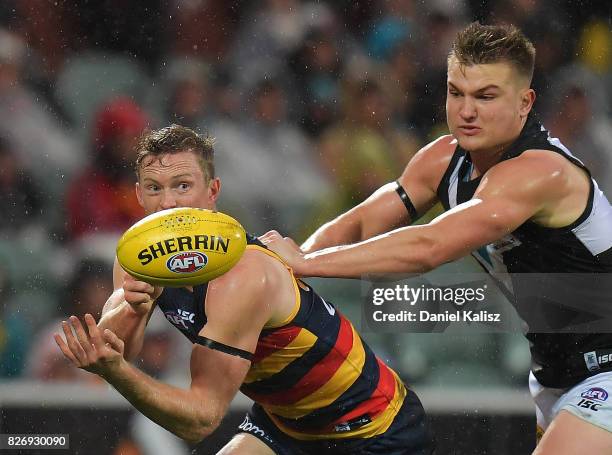 Alex Keath of the Crows handballs during the round 20 AFL match between the Adelaide Crows and the Port Adelaide Power at Adelaide Oval on August 6,...