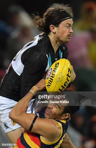 Eddie Betts of the Crows competes for the ball with Jasper Pittard of the Power during the round 20 AFL match between the Adelaide Crows and the Port...