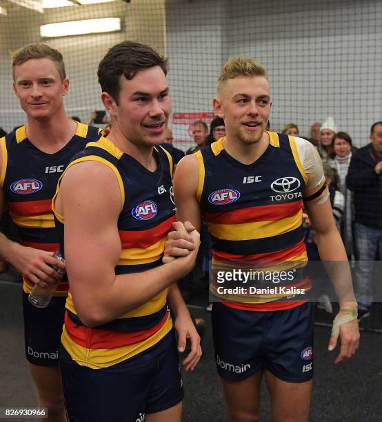 Mitch McGovern congratulates Hugh Greenwood of the Crows after the round 20 AFL match between the Adelaide Crows and the Port Adelaide Power at...