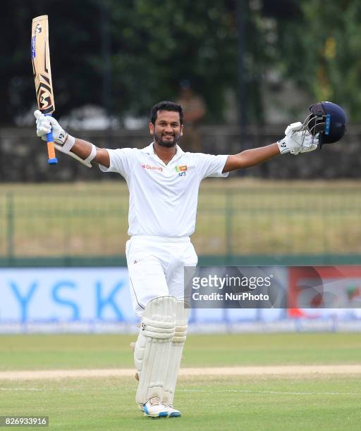 Sri Lankan cricketer Dimuth Karunaratne celebrates after scoring a century during the 4th Day's play in the 2nd Test match between Sri Lanka and...