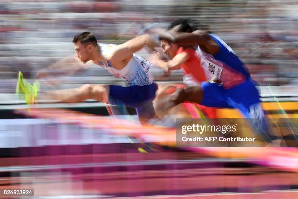 Britain's Andrew Pozzi, China's Xie Wenjun and Cuba's Roger Iribarne compete in the heats of the men's 110m hurdles athletics event at the 2017 IAAF...