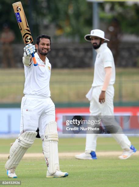 Sri Lankan cricketer Dimuth Karunaratne celebrates after scoring a century during the 4th Day's play in the 2nd Test match between Sri Lanka and...