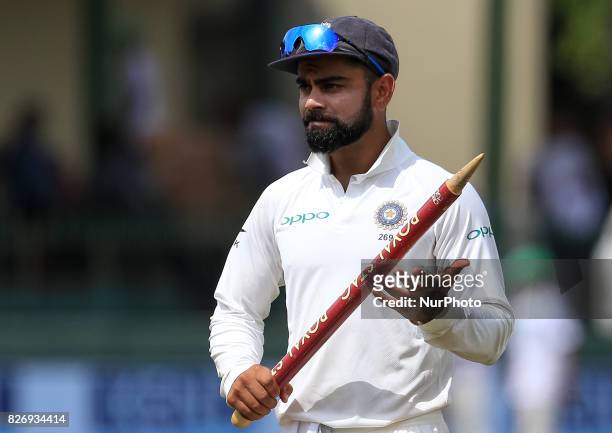 Indian captain Virat kohli walks off with a stump in his hand after India defeated Sri Lanka by an innings and 53 runs during the 4th Day's play in...