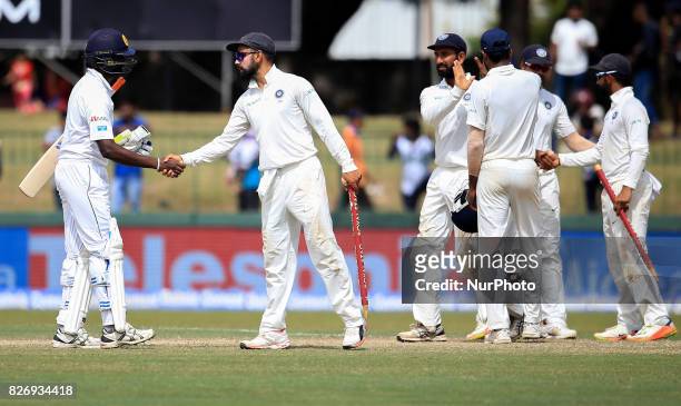 Indian captain Virat Kohli is congratulated by Sri Lanka's Nuwan Pradeep after India defeated Sri Lanka by an innings and 53 runs during the 4th...