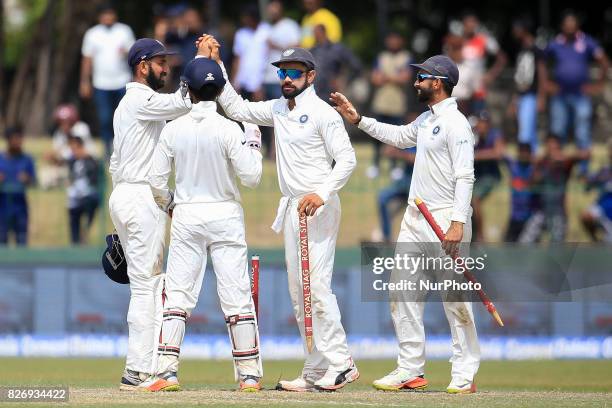 Indian captain Virat Kohli walks off with a stump in his hand after India defeated Sri Lanka by an innings and 53 runs during the 4th Day's play in...