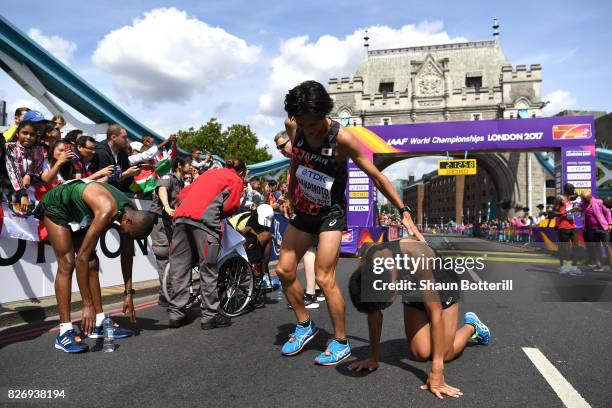 Kentaro Nakamoto of Japan and Hiroto Inoue of Japan react after crossing the finishline in the Men's Marathon during day three of the 16th IAAF World...