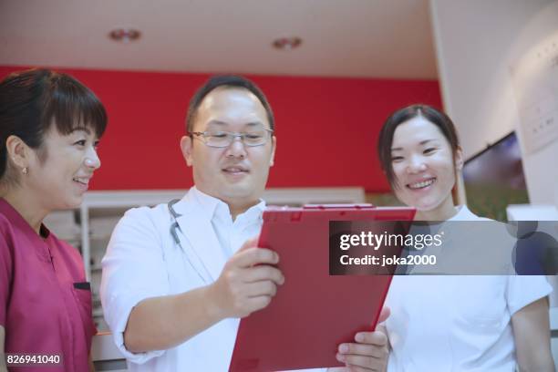 medische staf bespreken in ziekenhuis - 医療従事者 stockfoto's en -beelden