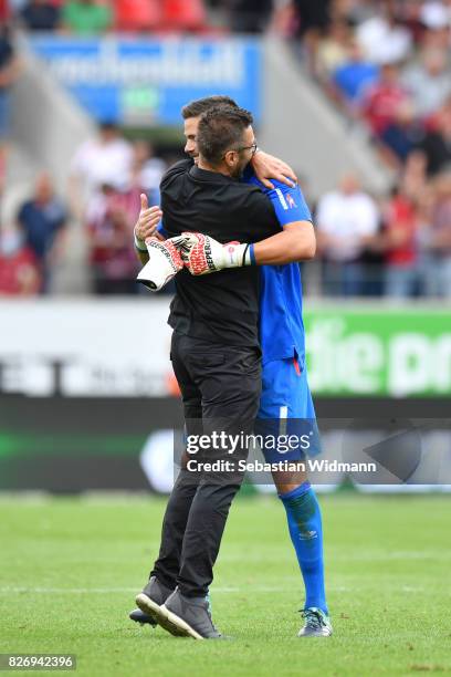 Head coach Michael Koellner hugs goalkeeper Thorsten Kirschbaum of 1. FC Nuernberg after the Second Bundesliga match between SSV Jahn Regensburg and...