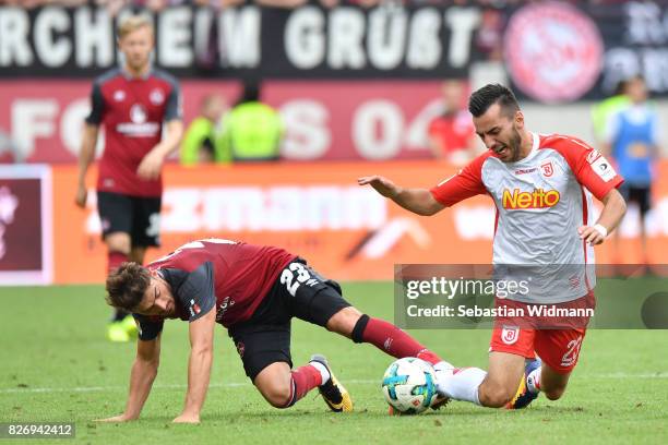 Tim Leibold of 1. FC Nuernberg and Sargis Adamyan of SSV Jahn Regensburg compete for the ball during the Second Bundesliga match between SSV Jahn...