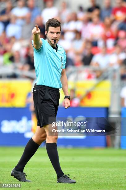 Referee Harm Osmers gestures during the Second Bundesliga match between SSV Jahn Regensburg and 1. FC Nuernberg at Continental Arena on August 6,...