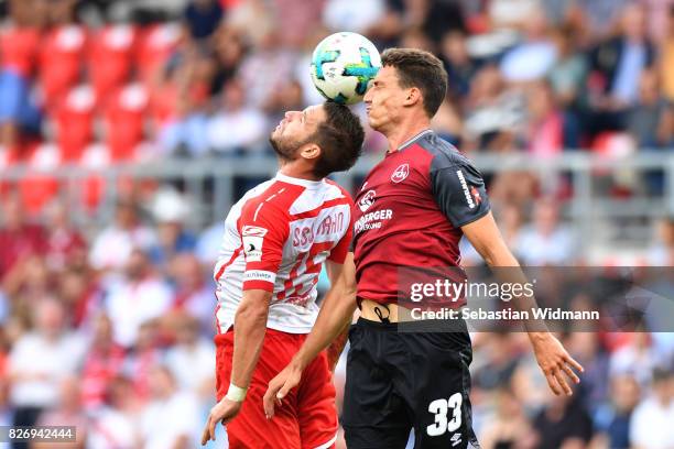 Marco Gruettner of SSV Jahn Regensburg and Georg Margreitter of 1. FC Nuernberg jump for a header during the Second Bundesliga match between SSV Jahn...