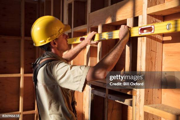 home building - measuring wall - male with spirit level stock pictures, royalty-free photos & images
